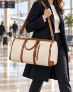 The Folvia Bag in Sand carried on the shoulder at the airport