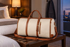 The Folvia Bag closed as a duffel on a hotel luggage bench